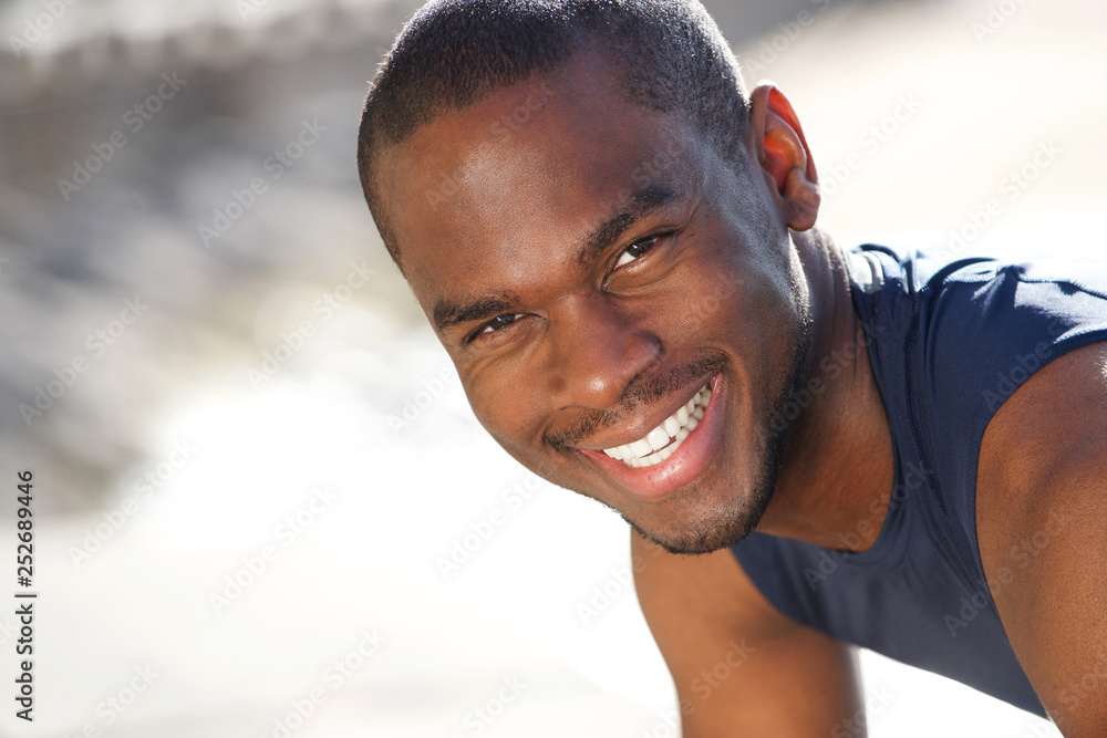 Close up smiling young african american sports man outdoors
