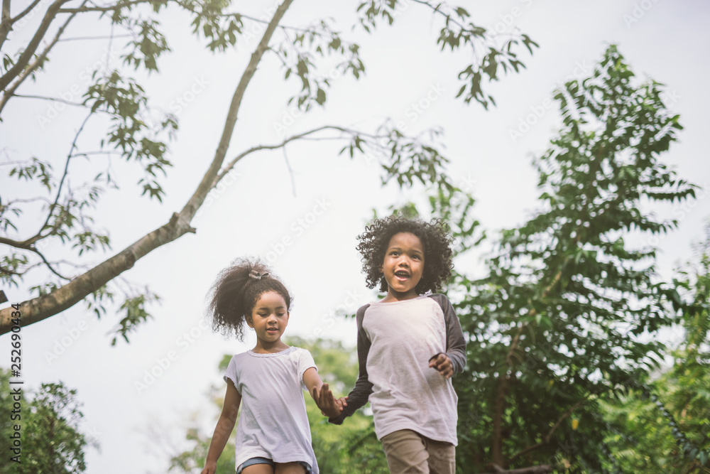 kids playing outdoors with friends. little children play at nature park. kids playing outdoors with friends. little children play at nature park.