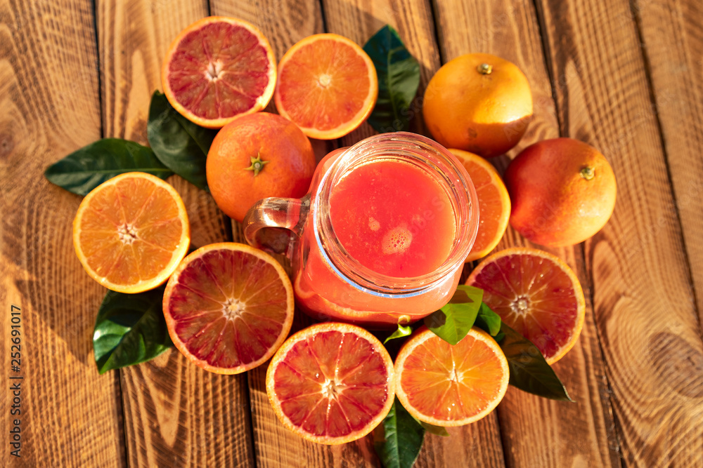 Orange juice of fresh blood oranges. Top view, outdoor shot in the sunshine Orange juice of fresh blood oranges. Top view, outdoor shot in the sunshine