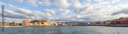 Fototapeta Naklejka Na Ścianę i Meble -  The city of Chania is a port on the west coast of the Cretan Sea in Greece. A tourist attraction, a long quay, interesting architecture, a Turkish bath building, houses. Mountains on the horizon.