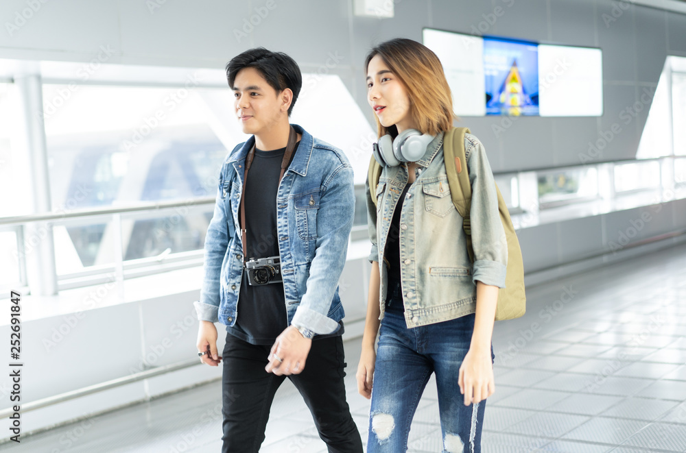 Young Asian travel couple walking around in Airport Lounge Happy Smile Man And Woman Flight Holiday Vacation Travel.Travelling concept.