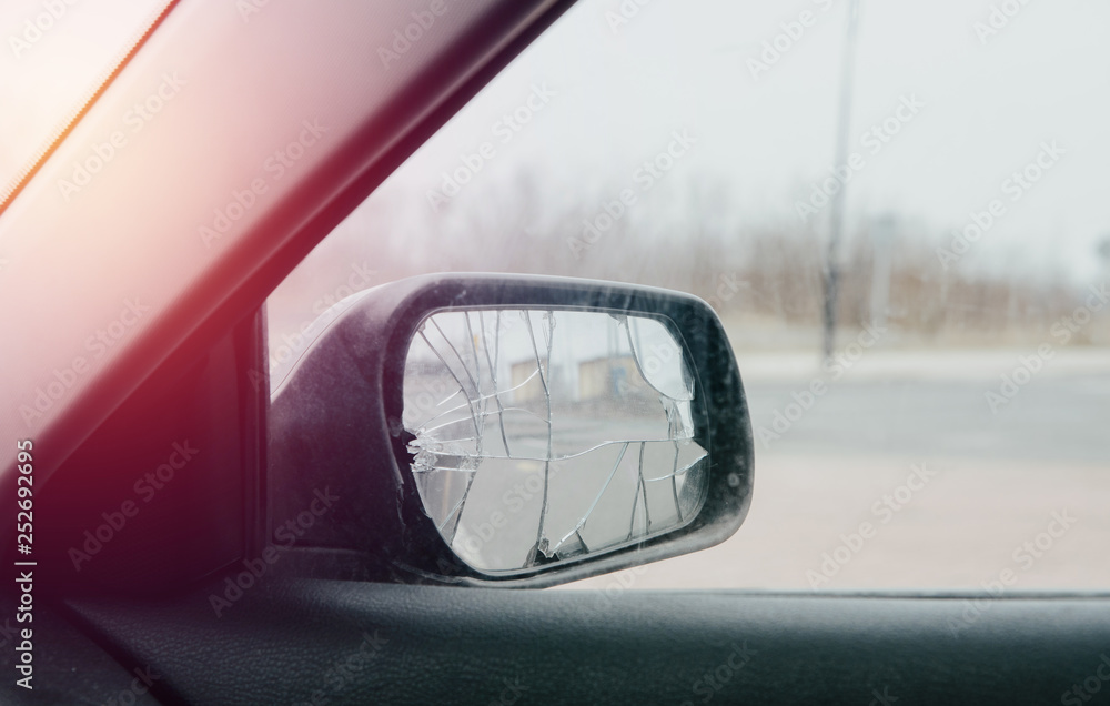 Broken car mirror. The car mirror is damaged, broken glass. Concept of accident, road collision. Damage to the side mirror, bad driving, problems with the car. Broken car mirror. The car mirror is damaged, broken glass. Concept of accident, road collision. Damage to the side mirror, bad driving, problems with the car.