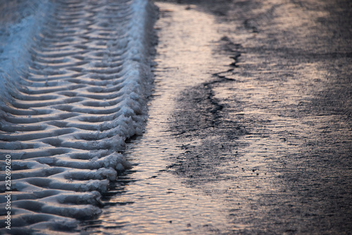 Tires tracks in melting snow