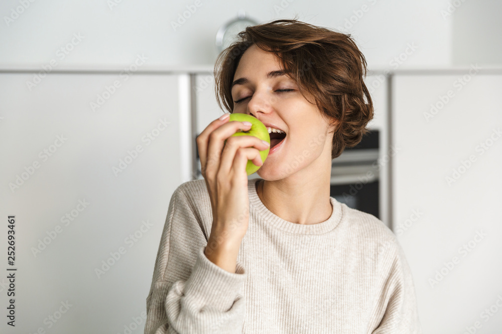 Smiling young woman holding green apple Smiling young woman holding green apple