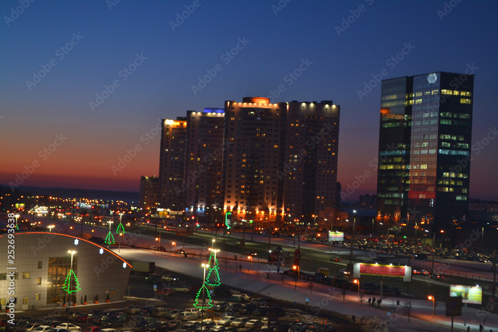 Beautiful metropolis city development, modern town with illumination. Panorama view of Minsk, Belarus. Night landscape with skyscrapers. Evening skyline. Sunset light. Modern business center