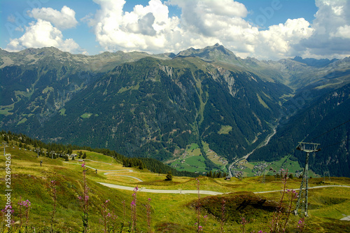rugged Austrian Alps mountain range and valley in summer sky