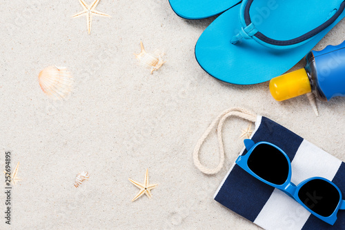 Beach accessory flat lay on sand, summer vacation design