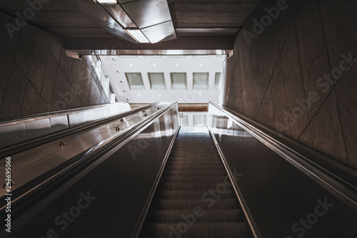 Escalator stairs going up towards the exit
