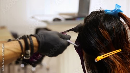 Professional hairdresser dyeing hair. Multicolor with stretching coloring