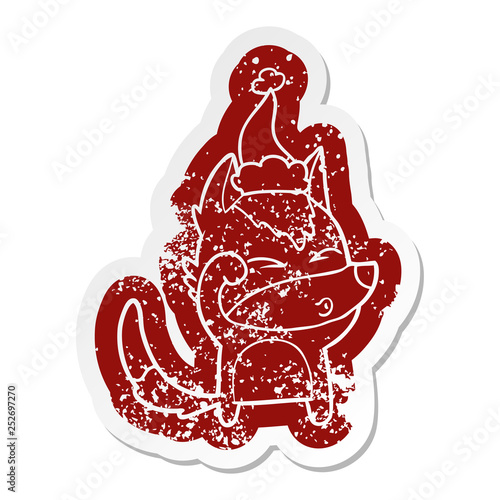 cartoon distressed sticker of a wolf pouting wearing santa hat
