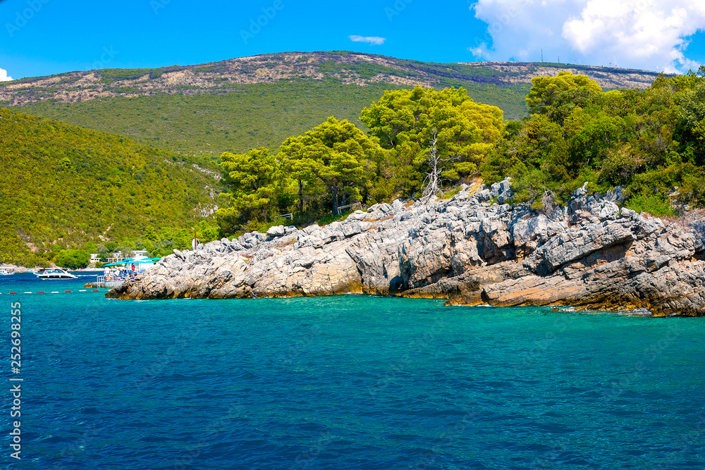 Incredible bright seascape. View of the rocks, the forest and the blue sea. Boka Kotorska Bay, Montenegro