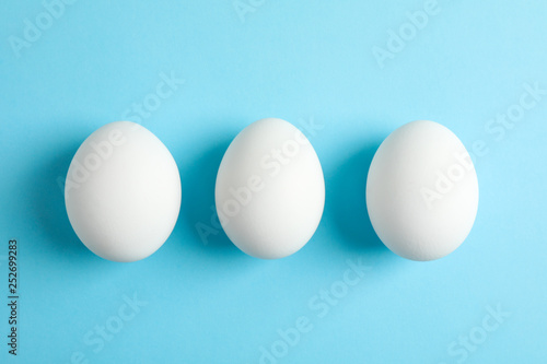 Chicken eggs on color background, space for text