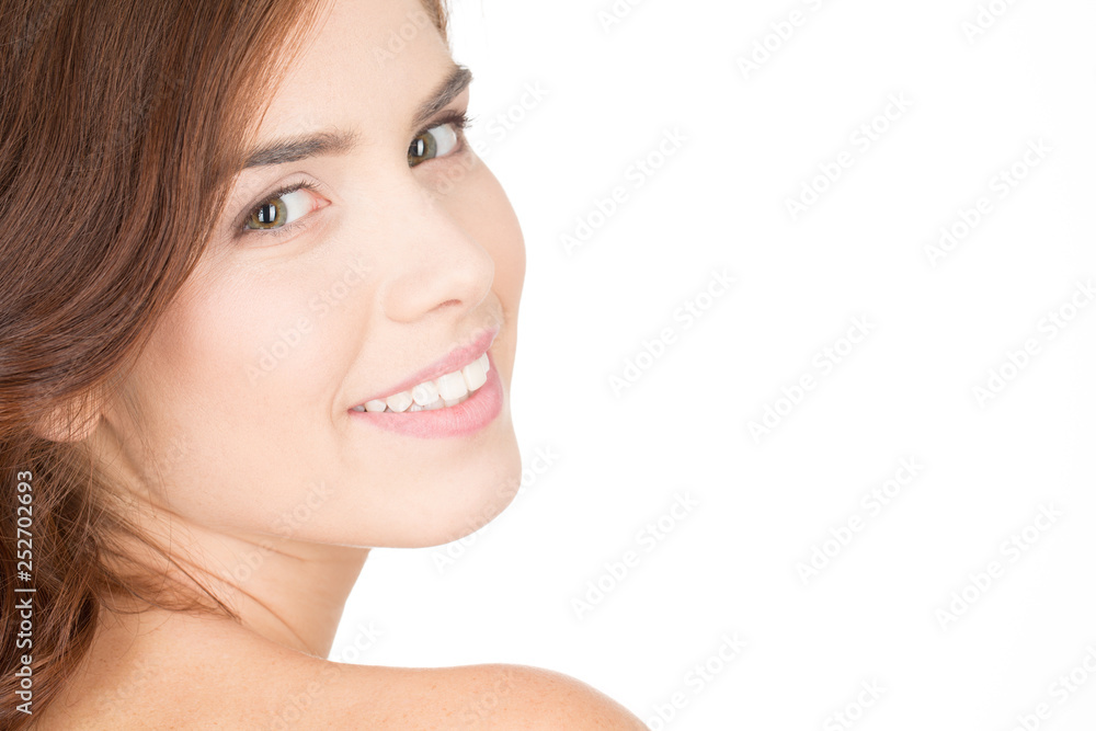 That look. Cropped beauty shot of a smiling girl with perfect skin looking to the camera over the shoulder That look. Cropped beauty shot of a smiling girl with perfect skin looking to the camera over the shoulder