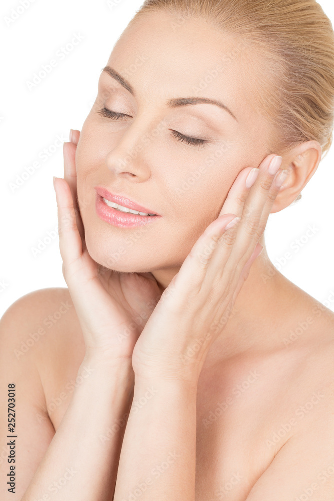 Feel the softness. Closeup of a beautiful middle aged female touching her face and smiling with her eyes closed