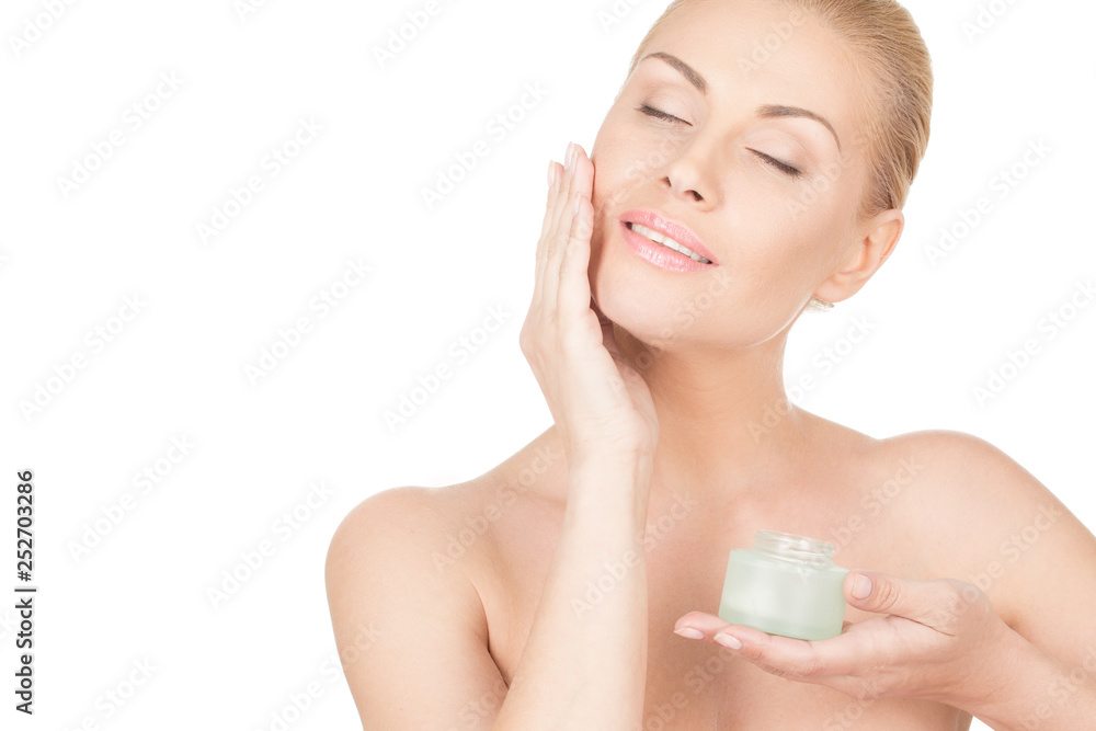 She knows what her skin needs. Horizontal portrait of a beautiful mature woman gently applying face cream and smiling isolated on white She knows what her skin needs. Horizontal portrait of a beautiful mature woman gently applying face cream and smiling isolated on white
