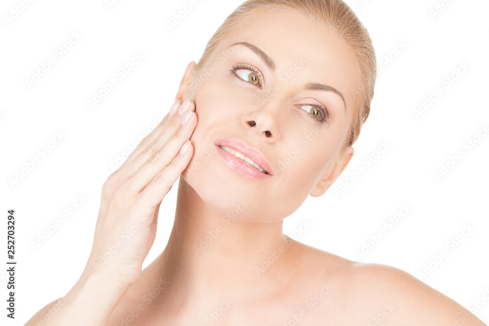 Her silky smooth skin. Closeup studio portrait of a gorgeous happy woman applying moisturizer to her face Her silky smooth skin. Closeup studio portrait of a gorgeous happy woman applying moisturizer to her face