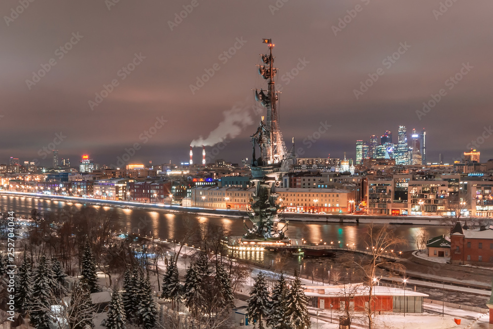 Aerial view to the iluminated city center of Moscow during evening time. Monument to Peter the Great