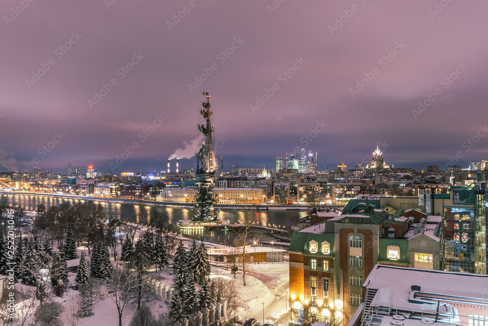 Aerial view to the iluminated city center of Moscow during evening time. Frozen Moscow riwer