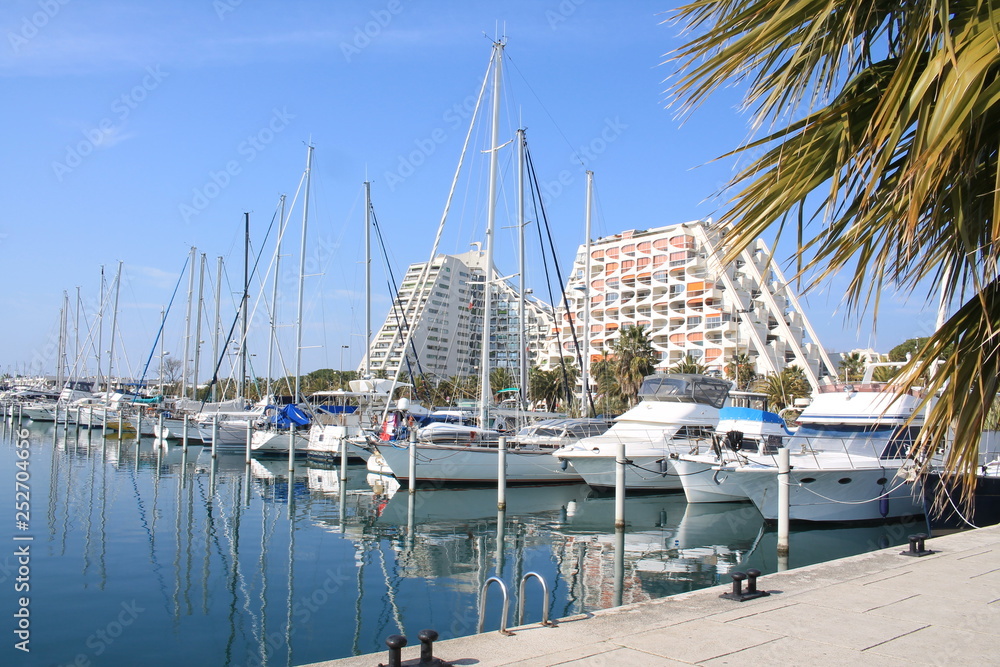 Pyramids buildings and pleasure boats in the seaside resort and marina  of la Grande Motte in Herault department, France
