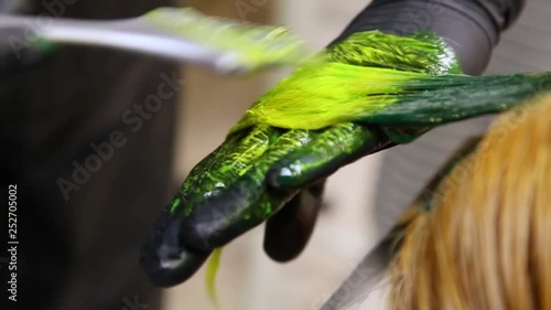 Professional hairdresser dyeing hair. Multicolor with stretching coloring. Fluorescent staining
