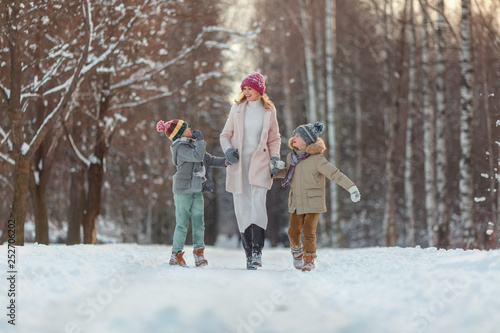 Cute children boy and mother playing in the winter. Happy kids outdoors