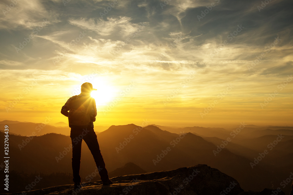 Hiker meets the sunset on the Moro rock in Sequoia national park, California, USA. Hiker meets the sunset on the Moro rock in Sequoia national park, California, USA.