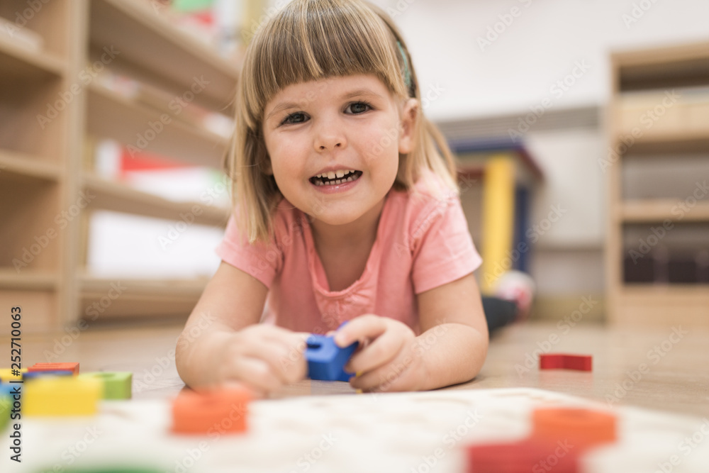 Smiling kid playing and learning alphabet Smiling kid playing and learning alphabet