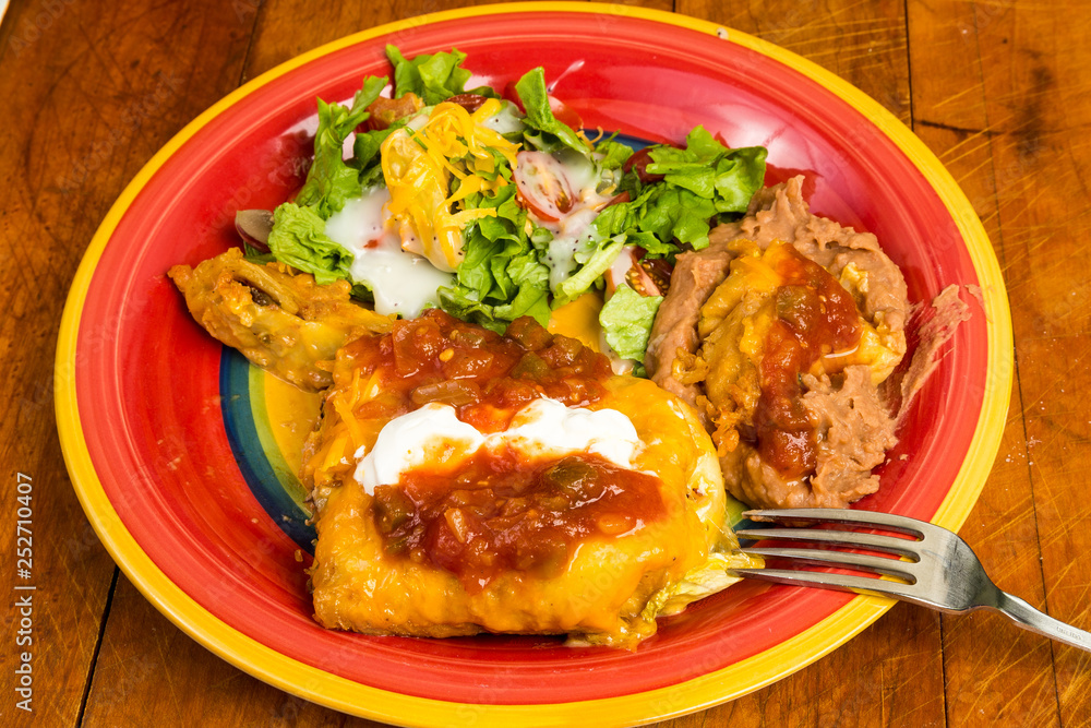 Chimichanga Mexican Dinner with Refired Beans and Salad on Colorful Plate Chimichanga Mexican Dinner with Refired Beans and Salad on Colorful Plate