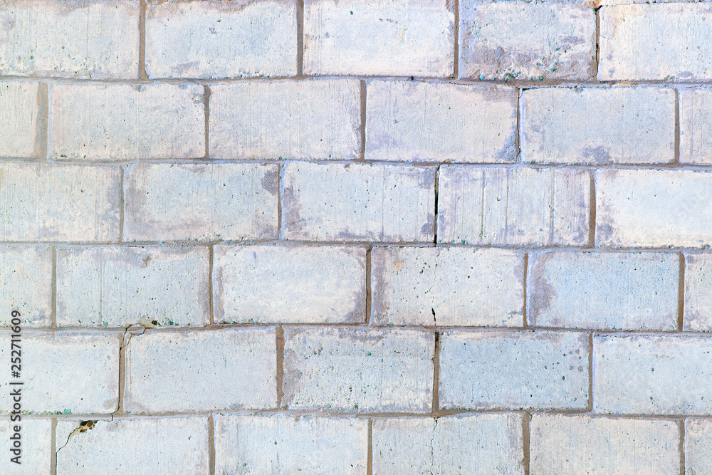 Background with brickwork texture. Light gray wall lined with large bricks. Background with brickwork texture. Light gray wall lined with large bricks.