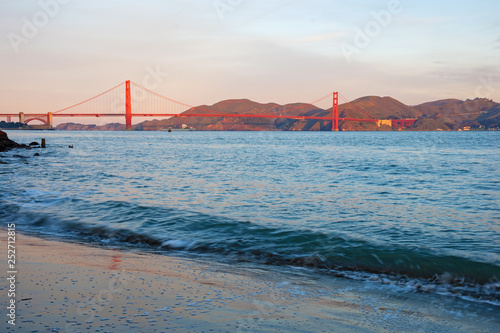 Golden Gate Bridge, the most recognized symbol of San Francisco, in warm red color of aurora