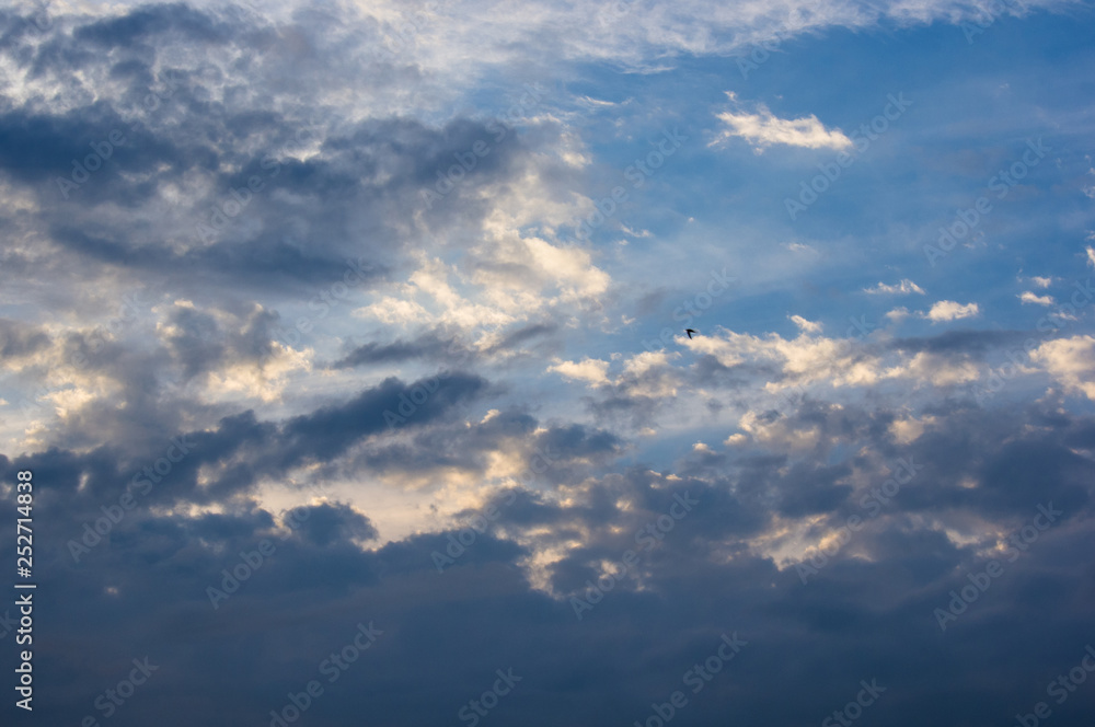 Landscape with dramatic light - beautiful golden sunset with saturated sky and clouds.