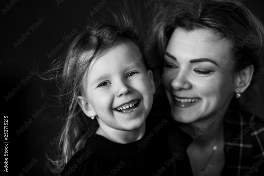 studio portrait of happy mom and daughter, classic strict style clothes studio portrait of happy mom and daughter, classic strict style clothes