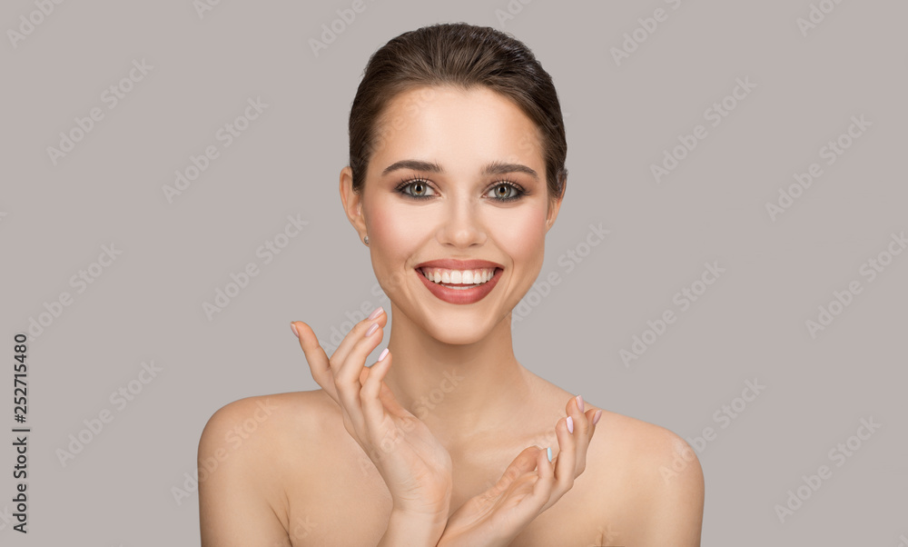 Portrait of young woman. Perfect clean skin and beautiful smile. Gray background. Portrait of young woman. Perfect clean skin and beautiful smile. Gray background.