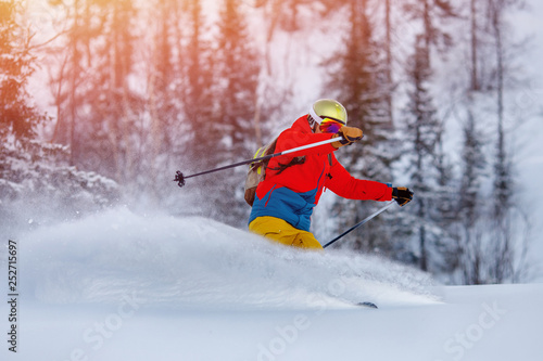 Man athlete mountain skiing rides on soft snow track in woods, chest action camera. Extreme concep