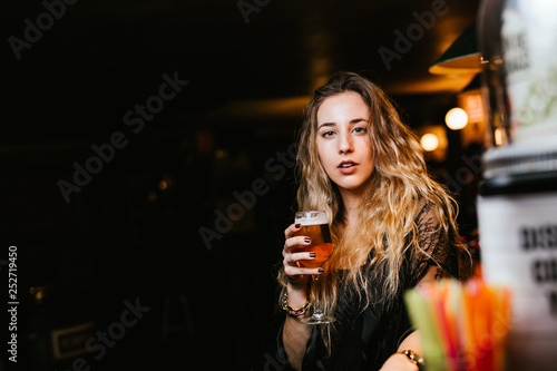 Young woman enjoys a beer