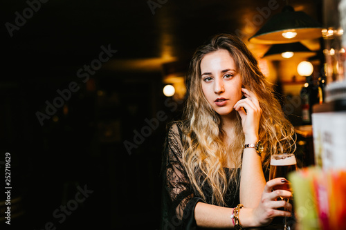 Young woman enjoys a beer