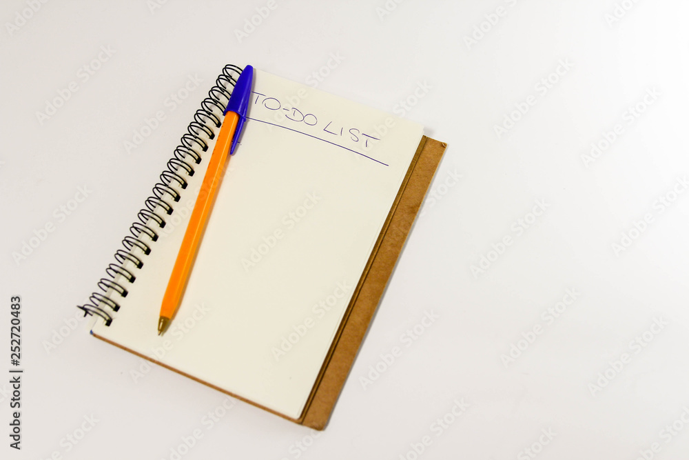 To do list in spiral notepad. White background, flat lay style. To do list in spiral notepad. White background, flat lay style.