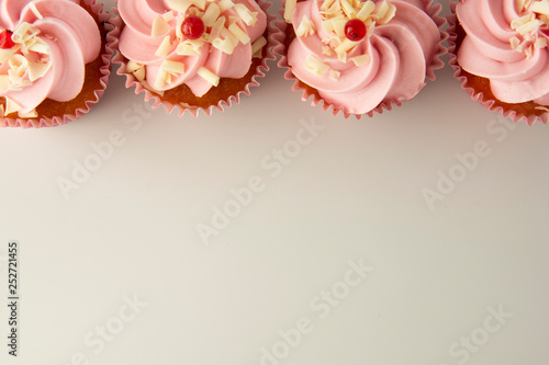 Pink, strawbery, fruit cupcakes isoalted. Sweet dessert, shortcakes with cream. Birthday food, cake, muffin. flat lay, copy space for text. Tempalte for food blog or food social media content.