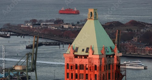 Ferry Sailing Beyond Rooftop At Dawn NYC