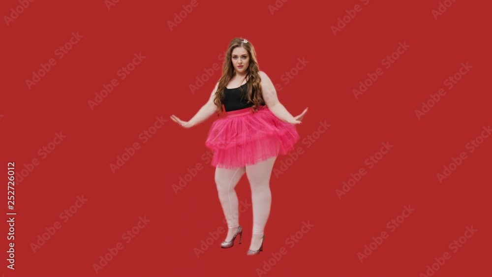 Overweight attractive young woman in a pink tutu Overweight attractive young woman in a pink tutu