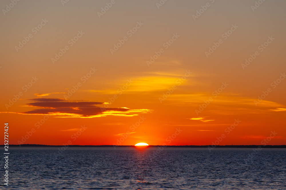 sun almost disappearing into the horizon sun almost disappearing into the horizon