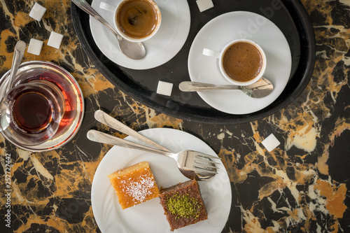 Obraz na płótnie traditional Turkish red black tea tulip glass green flowers sweet dessert afternoon tea break w salonie