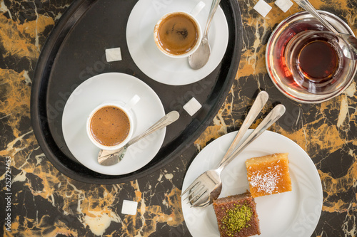 Obraz na płótnie traditional Turkish red black tea tulip glass green flowers sweet dessert afternoon tea break w salonie