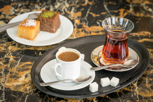 Obraz na płótnie traditional Turkish red black tea tulip glass green flowers sweet dessert afternoon tea break w salonie