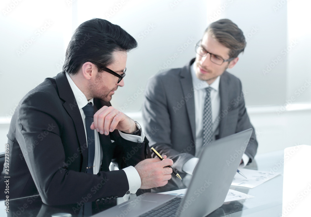 Two businessmen discussing at office during business meeting Two businessmen discussing at office during business meeting