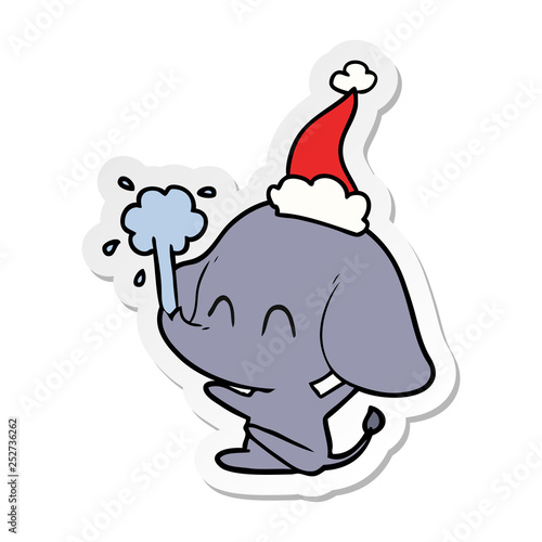 cute sticker cartoon of a elephant spouting water wearing santa hat
