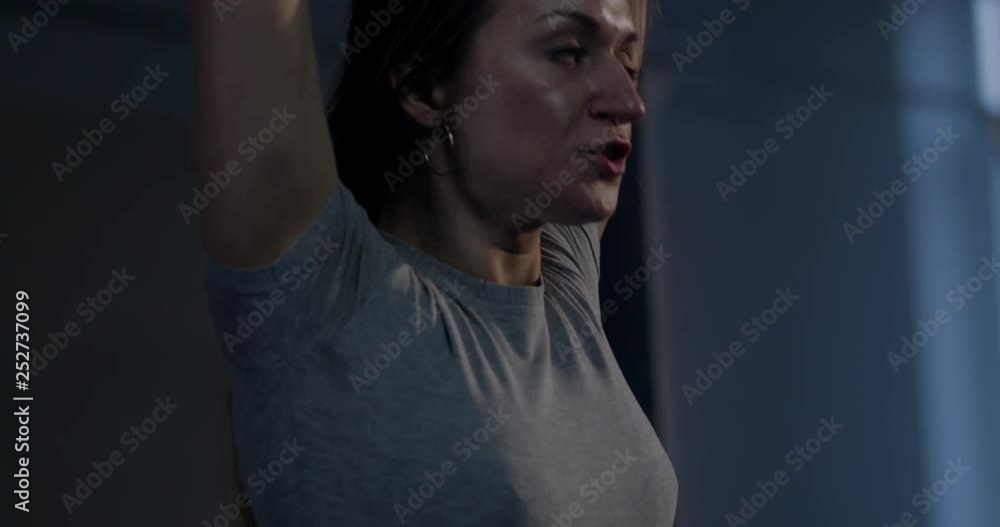 Caucasian female athlete working out with barbell in a gym. Functional workout. 4K UHD Caucasian female athlete working out with barbell in a gym. Functional workout. 4K UHD