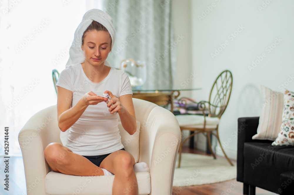 Beautiful woman applying moisturizing cream on her face at home Beautiful woman applying moisturizing cream on her face at home