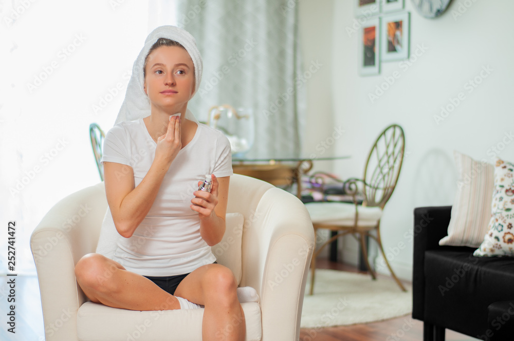 Beautiful woman removing makeup from her face at home Beautiful woman removing makeup from her face at home
