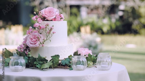 Dolly shot White wedding cake with flowers